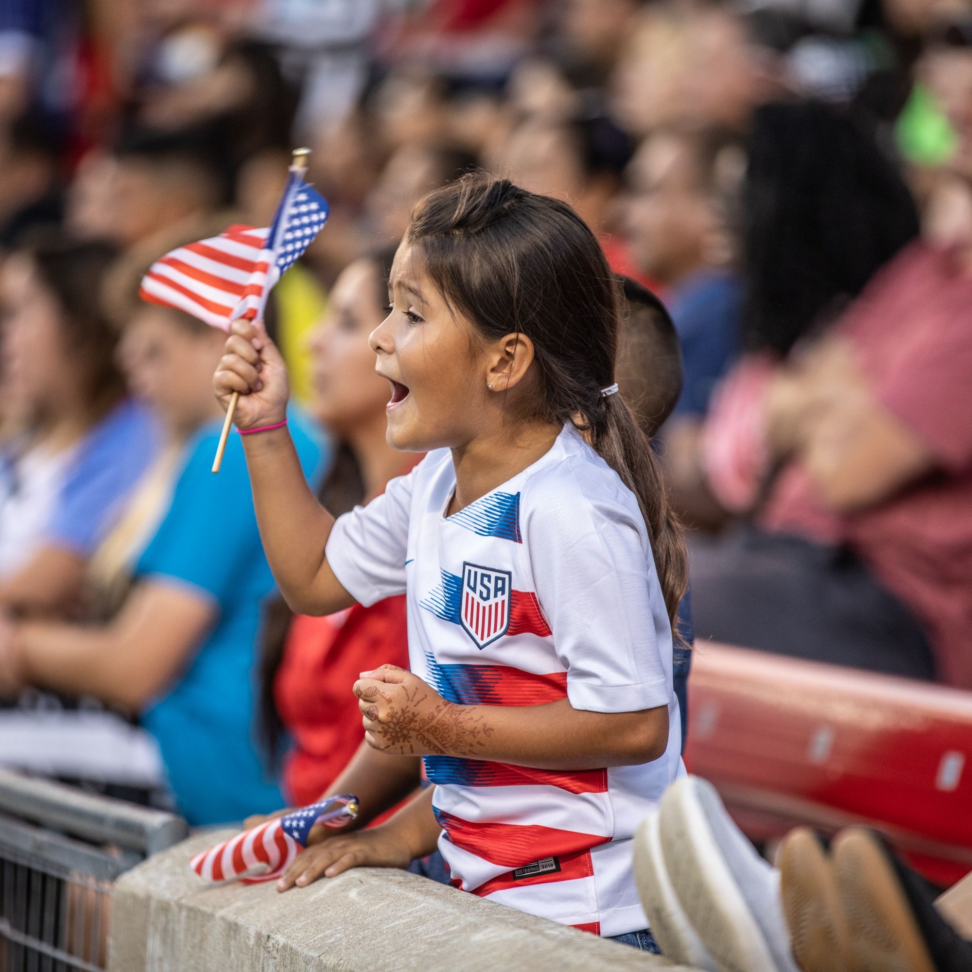 Girl cheering at USWNT game